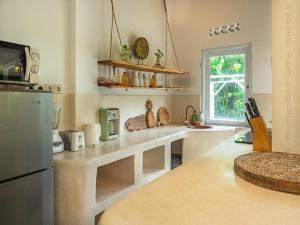 a kitchen with a counter and a refrigerator at Villa Medori - Private Pool Seminyak in Seminyak