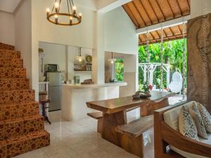 a kitchen and living room with a table and a dining room at Medori Villa Seminyak in Seminyak