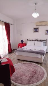 a bedroom with a large bed and a red rug at Malia Holiday Let in Famagusta