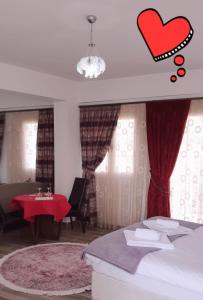 a bedroom with a bed and a red heart on the window at Malia Holiday Let in Famagusta