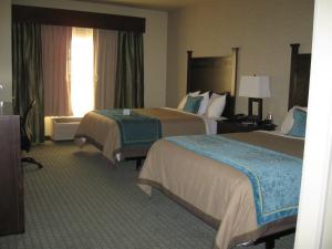 A bed or beds in a room at Little Missouri Inn & Suites New Town