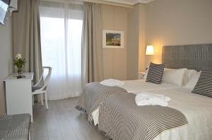 Łóżko lub łóżka w pokoju w obiekcie Ares Hotel