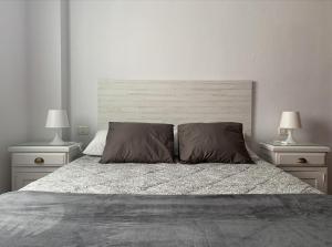 a bedroom with a large bed with two night stands at Vivienda vacacional La Plaza in Santa Úrsula