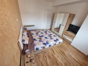 a small bedroom with a bed and a tv at Atena Apartment in Ohrid