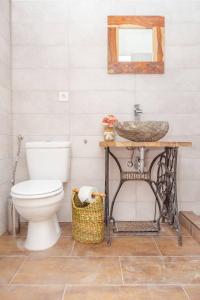 a bathroom with a sink and a toilet at Tugári Vendégház in Hollókő