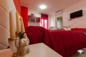 sala de estar con mesa y cortina roja en Dimora Diamante en Manfredonia