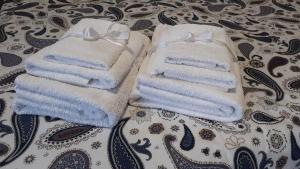 two towels sitting on top of a bed at Casa dell'Artista 1 in Salerno +14 photos