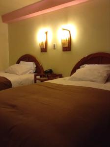 Postel nebo postele na pokoji v ubytování Royal Inn Hotel Juliaca