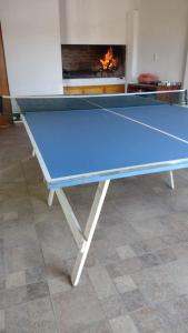a ping pong table in a room with a fireplace at Eljacaranda_ in Gualeguay