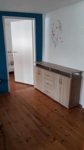 an empty room with a counter and a door at Fewo Kastel in Nonnweiler