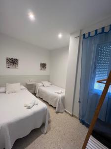 Postel nebo postele na pokoji v ubytování Apartamentos Ortega