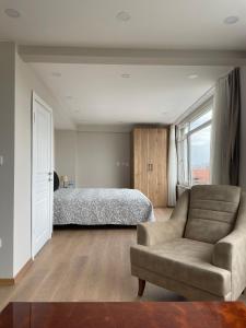 a bedroom with a bed and a couch and a chair at Kuzguncuk View in Istanbul