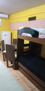 Cette chambre comprend 2 lits superposés et une chaise. dans l'établissement Quitinete Expominas Suite e Ar, à Belo Horizonte