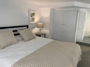 a bedroom with a large white bed with two pillows at Loft Manuel de Falla in Maracena