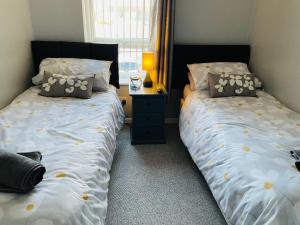two beds sitting next to each other in a bedroom at The Beach House, Suffolk Coast in Lowestoft +21 photos