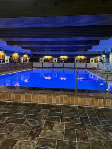 a large swimming pool with blue water at night at Fewo Berlik in Bad Harzburg
