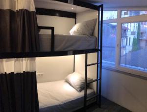 two bunk beds in a room with a window at Musk24H in Istanbul