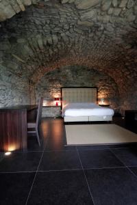 A bed or beds in a room at Hotel Corte Santa Libera