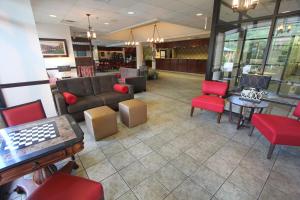 a waiting room with a couch and red chairs at Black Bear Inn & Suites in Gatlinburg