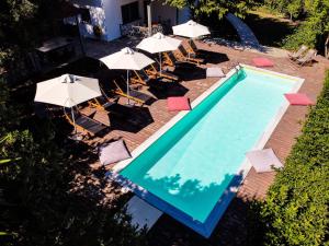 an overhead view of a swimming pool with chairs and umbrellas at Casa Villa, Xenia Paliouri in Paliouri