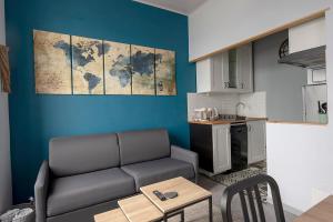 a living room with a couch and a kitchen at Studio cozy proche Intra-Muros in Saint Malo +11 photos