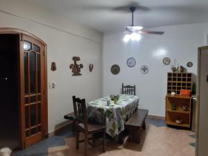 a dining room with a table and chairs and a ceiling at Lo de Nor in Tigre
