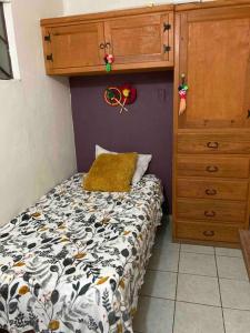 ein kleines Schlafzimmer mit einem Bett und einer Kommode in der Unterkunft Acogedora habitación privada en Jalatlaco in Oaxaca de Juárez
