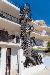 a spiral staircase on the side of a building at Fior di Sicilia Loft in Marzamemi