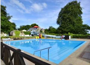 a large blue swimming pool with a rail at Woodlands Hedgehog Chalet, Bideford Bay Holiday Park in Bucks Mills