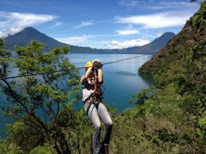 a person on a mountain with a camera at Reserva Natural Atitlan in Panajachel