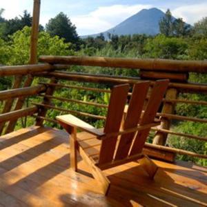 a wooden bench sitting on top of a wooden deck at Reserva Natural Atitlan in Panajachel