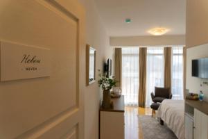 a hotel room with a bed and a chair at Herceg Vila in Trebinje