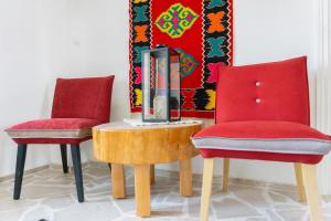 two red chairs and a table in a room at Herceg Vila in Trebinje