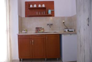 a small kitchen with a sink and a dishwasher at VARBENIS STUDIOS in Paralia Katerinis