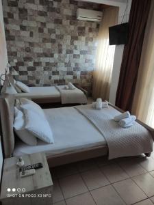 A bed or beds in a room at VARBENIS STUDIOS