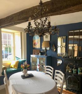 a dining room with a table and a chandelier at Clarke’s Farm in Heighington