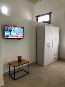 a room with a table and a tv on the wall at Acogedor departamento bien ubicado in Concordia