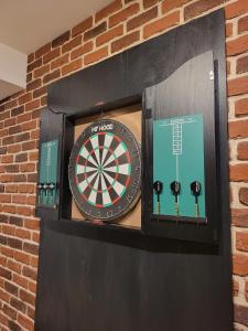 a dart board in a brick wall at SPAre-Time - Exclusive and Unique Apartment! 18+ in Oradea