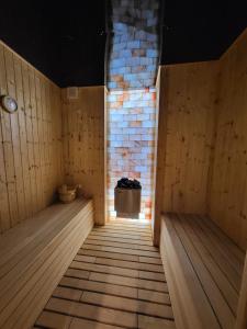 una sauna con suelo de madera y pared de ladrillo en SPAre-Time - Exclusive and Unique Apartment! 18+ en Oradea