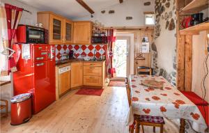 een keuken met een rode koelkast en een tafel bij Lovely Home In Lamastre With Kitchen in Lamastre
