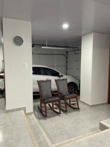 two chairs in a parking garage with a car at Casa Vacacional Villanueva in Villanueva