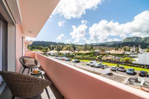 a balcony with a view of a parking lot at Furnas Apartment in Furnas