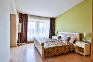 a bedroom with a bed and a large window at Modrá Stodola contactless check-in in Horoměřice