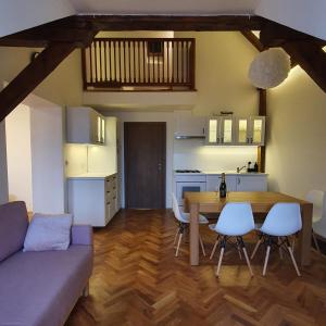 a kitchen and a living room with a table and chairs at Prague Castle View Apartment in Prague