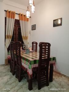 a dining room table with chairs and a table and a table and chairsktop at 'Franklyn', Homestay in Kalutara