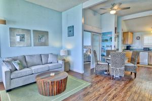a living room with a couch and a table at Sealodge G9 in Princeville