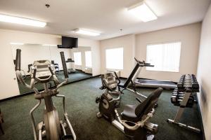a gym with two treadmills and two exercise bikes at Greystone Inn & Suites in Vance +12 photos