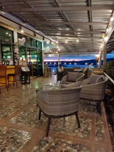 a lobby with couches and chairs and a table at Khong Chiam Orchid Riverside Resort in Khong Chiam