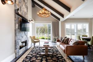 a living room with a couch and a fireplace at Brokenback Views Country Estate Hunter Valley in Pokolbin