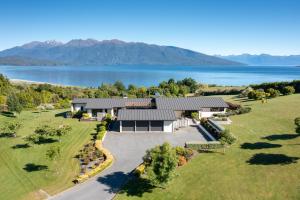an aerial view of a house with a lake at High Leys Lodge in Te Anau